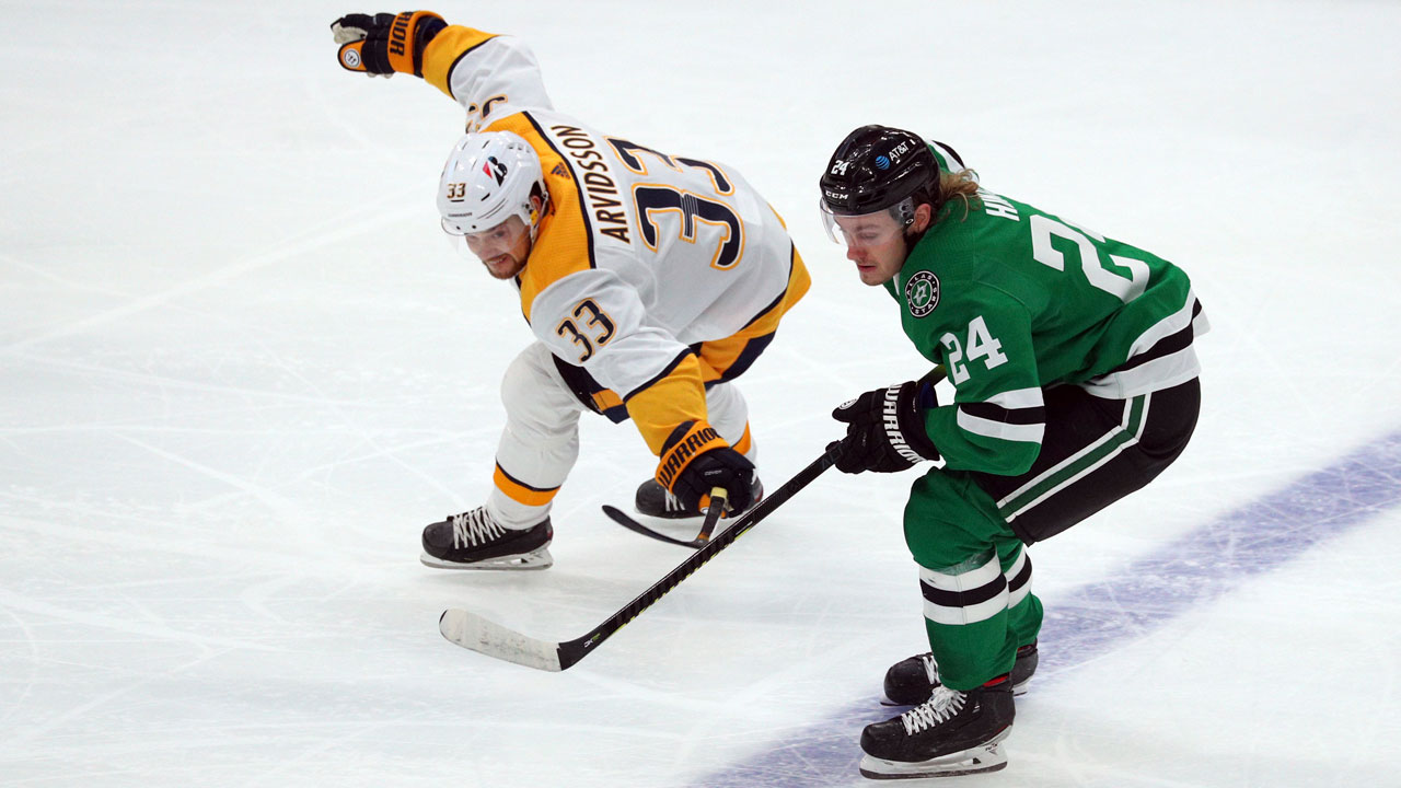 Nashville Predators right wing Viktor Arvidsson (33) tries to get the puck away from Dallas Stars left wing Roope Hintz (24). (Richard W. Rodriguez/AP)