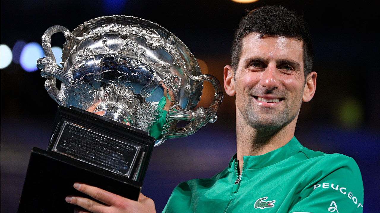 Novak Djokovic holds the Norman Brookes Challenge Cup after defeating Daniil Medvedev in the men's singles final at the Australian Open. (Andy Brownbill/AP)