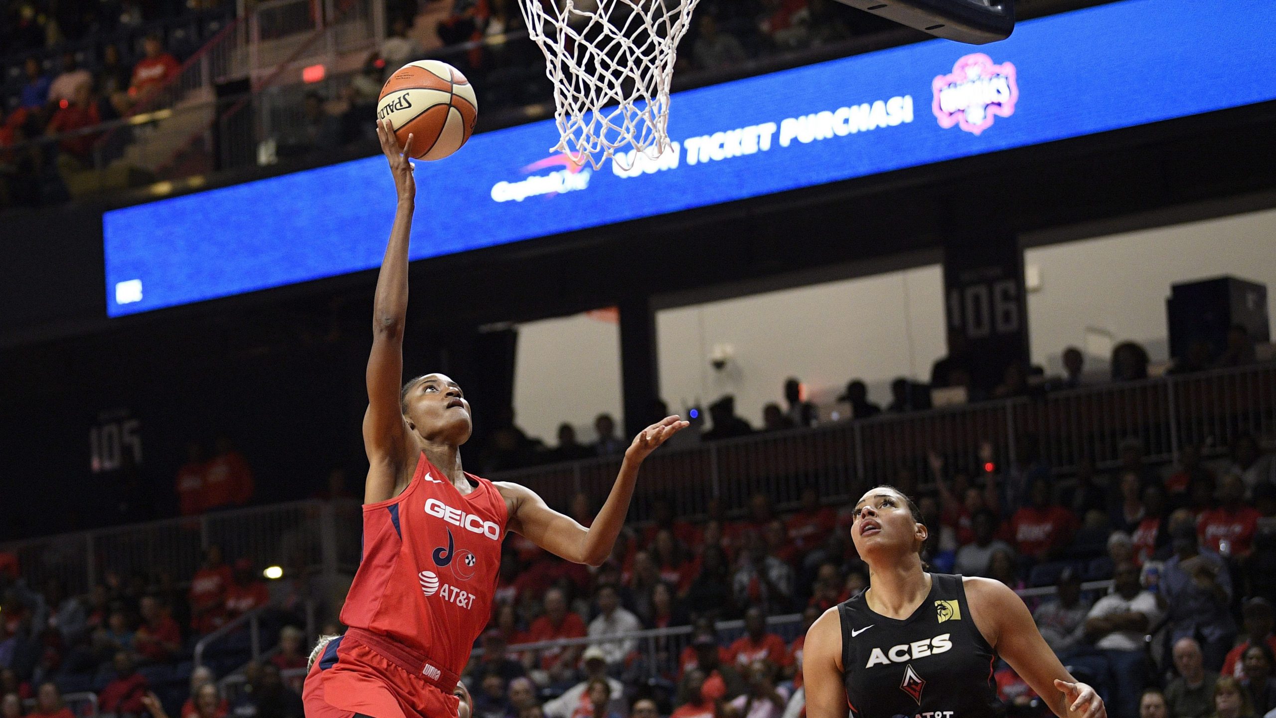 Washington Mystics forward LaToya Sanders, left, goes to the basket against Las Vegas Aces center Liz Cambage, right. (Nick Wass/AP)