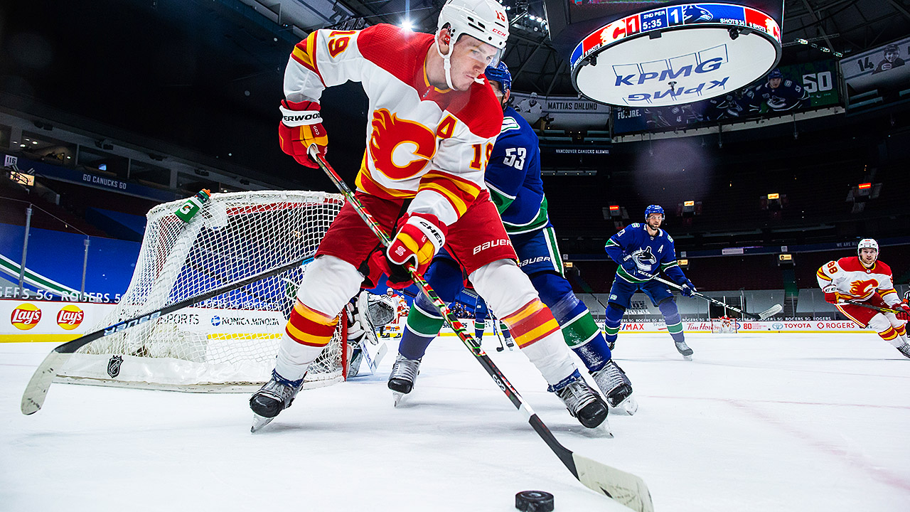 Calgary Flames forward Matthew Tkachuk controls the puck in front of Vancouver Canucks' Bo Horvat. (Darryl Dyck/CP)