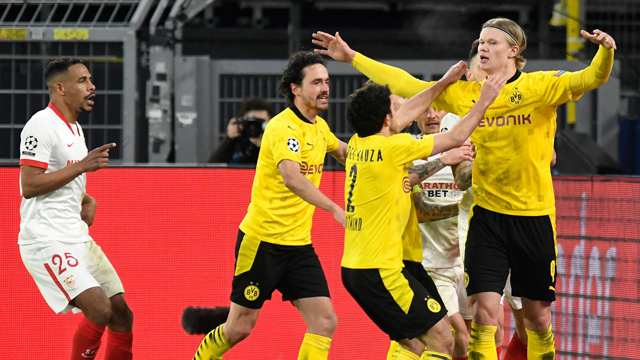 Dortmund's Erling Haaland, right, celebrates with teammates after scoring his sides second goal during the Champions League, round of 16, second leg match between Borussia Dortmund and Sevilla FC in Dortmund, Germany, Tuesday, March 9, 2021. (Bernd Thissen/Pool via AP)