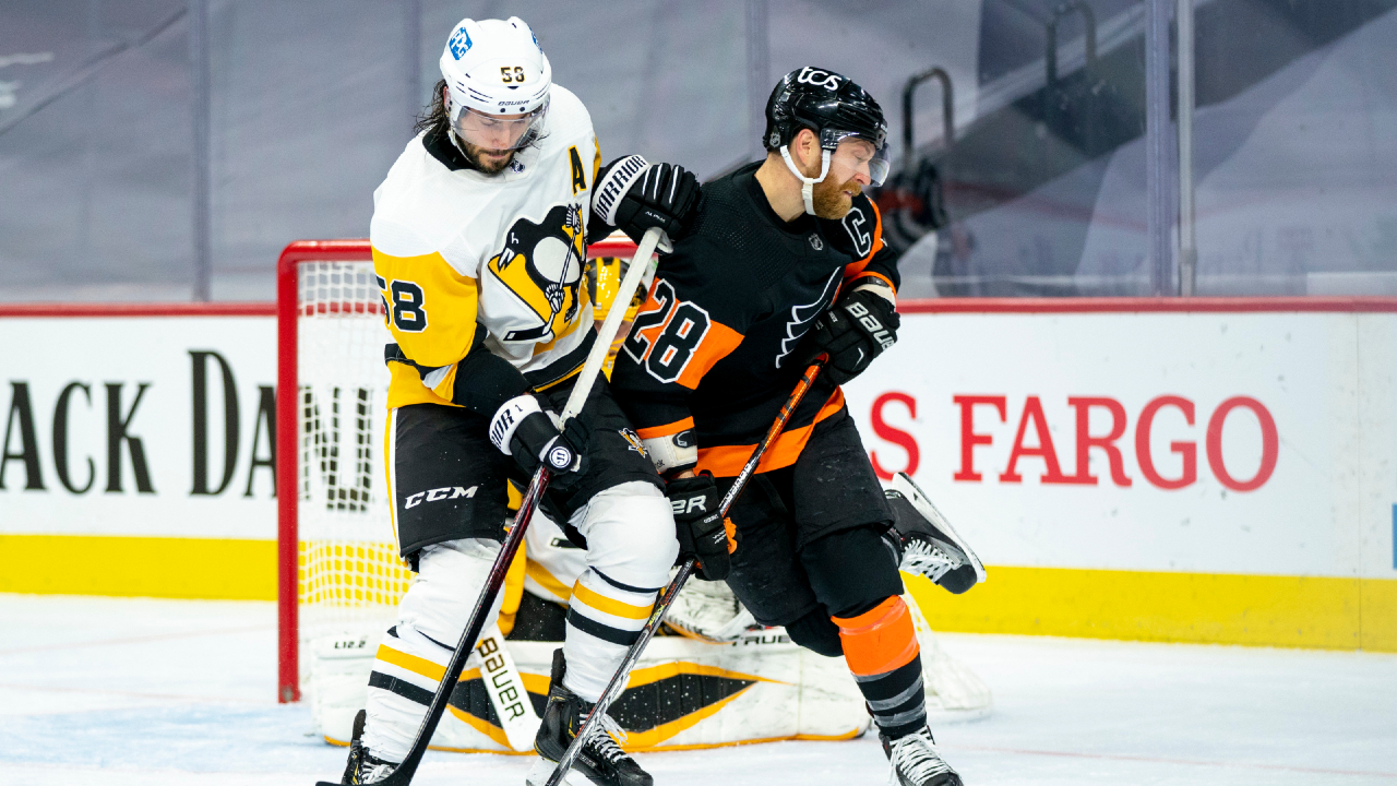 Pittsburgh Penguins' Kris Letang, left, knocks Philadelphia Flyers' Claude Giroux, right, away from the puck during the second period of an NHL hockey game, Friday, Jan. 15, 2021, in Philadelphia. (Chris Szagola/AP)
