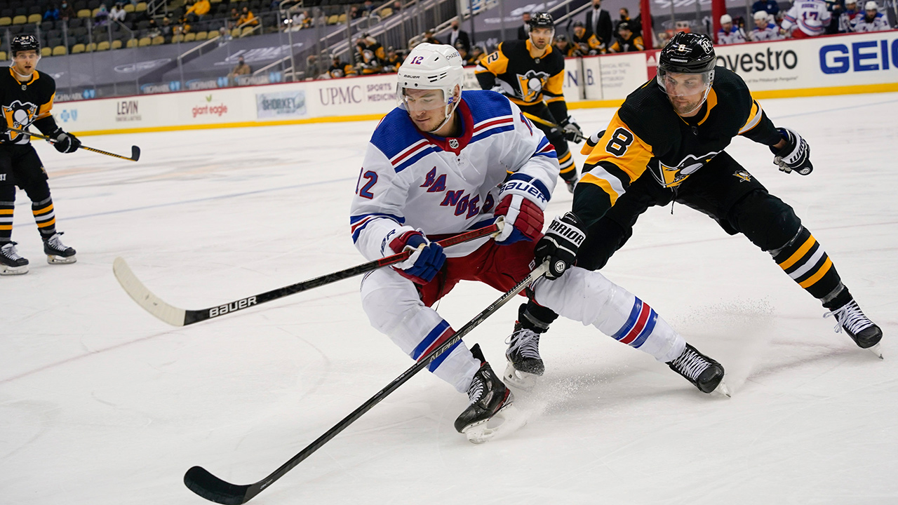 New York Rangers' Julien Gauthier (12) and Pittsburgh Penguins' Brian Dumoulin (8) chase the puck during the second period of an NHL hockey game, Sunday, March 7, 2021, in Pittsburgh. (Keith Srakocic/AP)