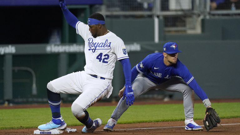 Kansas City Royals' Jorge Soler, left, beats the tag by Toronto Blue Jays third baseman Cavan Biggio to advance to third on a flyout by Michael A. Taylor during the fourth inning of a baseball game Thursday, April 15, 2021, in Kansas City, Mo. (Charlie Riedel/AP)