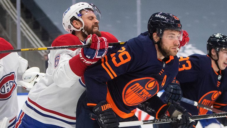 Edmonton Oilers' Leon Draisaitl (29) is cross checked by Montreal Canadiens' Shea Weber (6) during second period NHL action in Edmonton on Wednesday, April 21, 2021. (Jason Franson/CP)