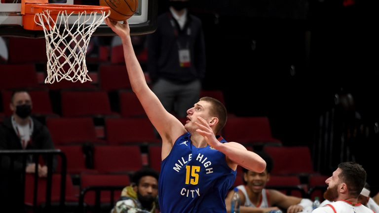 Denver Nuggets center Nikola Jokic drives to the basket past Portland Trail Blazers center Jusuf Nurkic, right, during the second half of an NBA basketball game in Portland, Ore., Wednesday, April 21, 2021. The Nuggets won 106-105. (Steve Dykes/AP)