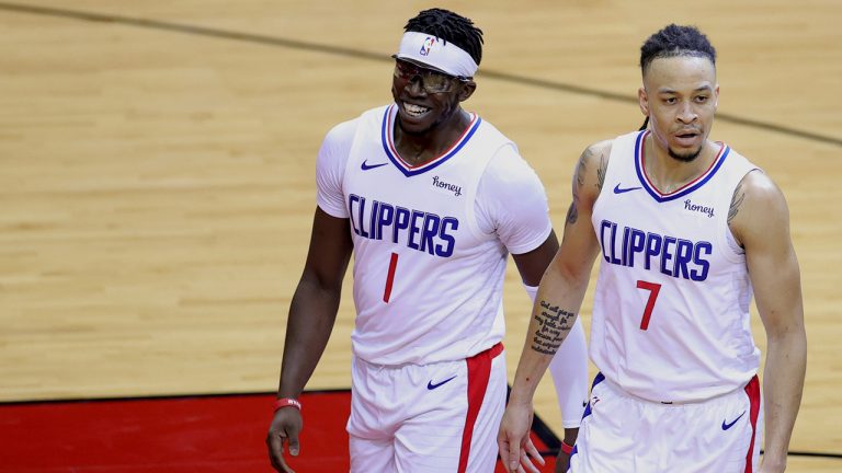 Los Angeles Clippers' Reggie Jackson (1) and Amir Coffey walk to the bench during the second quarter against the Houston Rockets in an NBA basketball game Friday, April 23, 2021, in Houston. (Carmen Mandato/Pool Photo via AP)