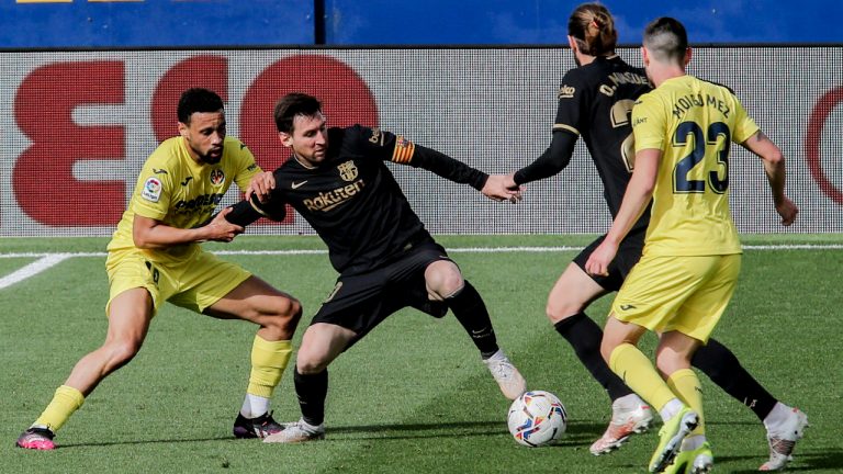 Barcelona's Lionel Messi, second left, vies for the ball with Villareal's Vicente Iborra during the Spanish La Liga soccer match between Villarreal and FC Barcelona at the Ceramica stadium in Villarreal, Spain, Sunday, April 25, 2021. (AP Photo/Alberto Saiz)