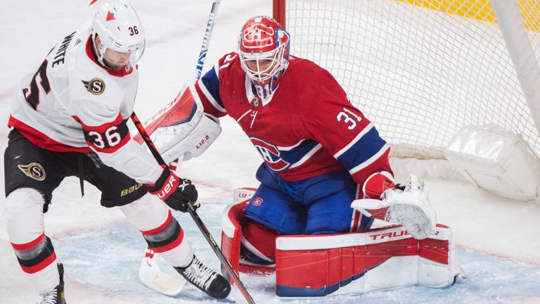 Ottawa Senators' Colin White moves in on Montreal Canadiens goaltender Carey Price during first period NHL hockey action in Montreal, Saturday, April 17, 2021. (Graham Hughes/CP)