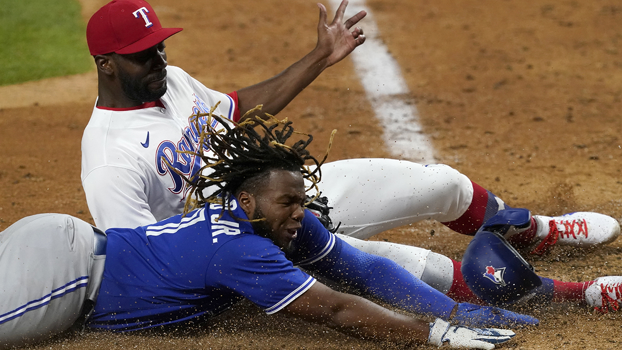 Texas Rangers' Nathaniel Lowe (30) is tagged out by Toronto Blue Jays  second baseman Cavan Biggio (8) during the 8th inning of a baseball game in  Arlington, Texas, Friday, June 16, 2023.