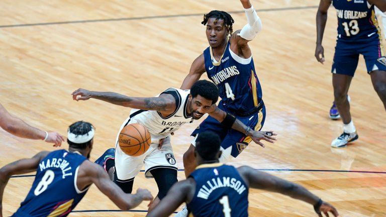 Brooklyn Nets guard Kyrie Irving (11) loses the ball as he drives the lane between New Orleans Pelicans forward Naji Marshall (8), forward Zion Williamson (1) and forward Wes Iwundu (4) in the first half of an NBA basketball game in New Orleans, Tuesday, April 20, 2021. (Gerald Herbert/AP)