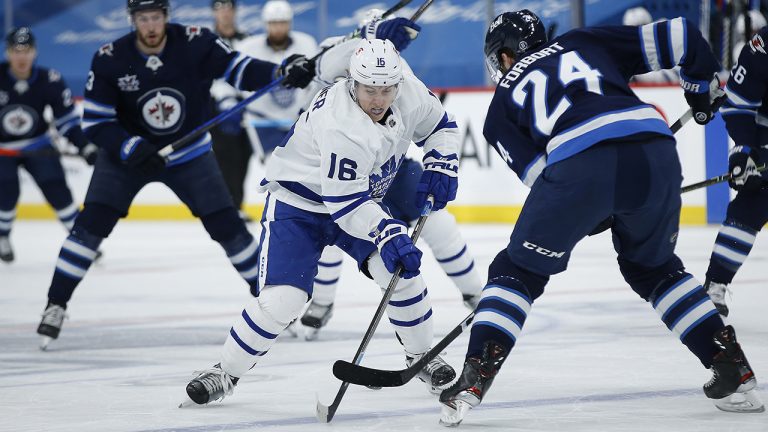 Winnipeg Jets' Derek Forbort (24) steals the puck from Toronto Maple Leafs' Mitchell Marner (16) during first period NHL action in Winnipeg. THE CANADIAN PRESS/John Woods