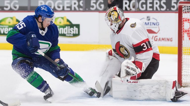 Ottawa Senators goalie Matt Murray (30) stops Vancouver Canucks' Matthew Highmore (15) during the second period of an NHL hockey game in Vancouver, on Thursday, April 22, 2021. (Darryl Dyck/CP)