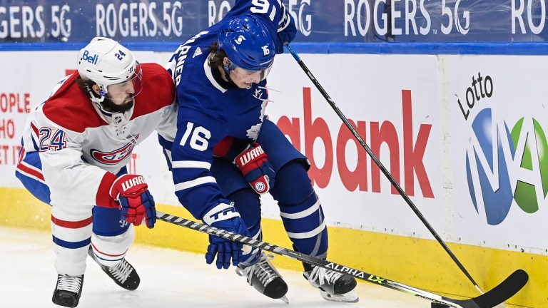 Toronto Maple Leafs forward Mitchell Marner (16) fights off Montreal Canadiens forward Phillip Danault (24) during third period NHL hockey action in Toronto on Wednesday, April 7, 2021. (Nathan Denette/CP)