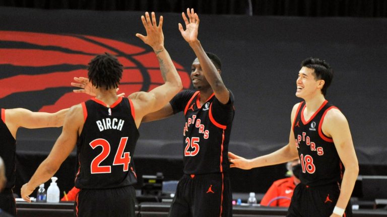 Toronto Raptors' Khem Birch (24) celebrates with Chris Boucher (25) and Yuta Watanabe (18) after Boucher scored a three-point basket late in the fourth quarter of a basketball game against the Oklahoma City Thunder, Sunday, April 18, 2021, in St. Petersburg, Fla. (AP Photo/Steve Nesius)
