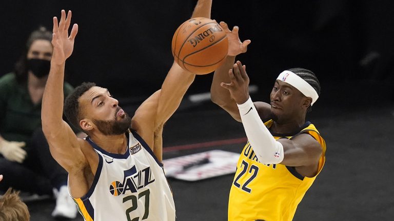 Utah Jazz center Rudy Gobert (27) defends against Indiana Pacers guard Caris LeVert (22) during the first half of an NBA basketball game Friday, April 16, 2021, in Salt Lake City. (Rick Bowmer/AP)