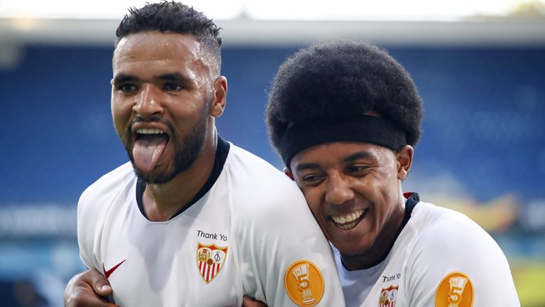 Sevilla's Youssef En-Nesyri celebrates with Sevilla's Jules Kounde after scoring. (Wolfgang Rattay/Pool Photo via AP)