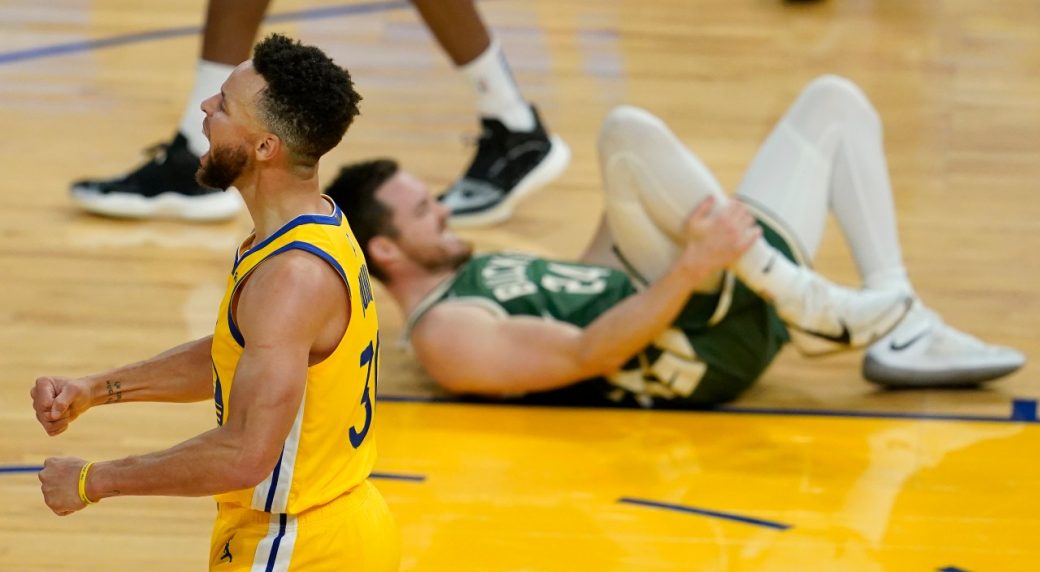 Curry, Warriors use furious finish to hold off Bucks