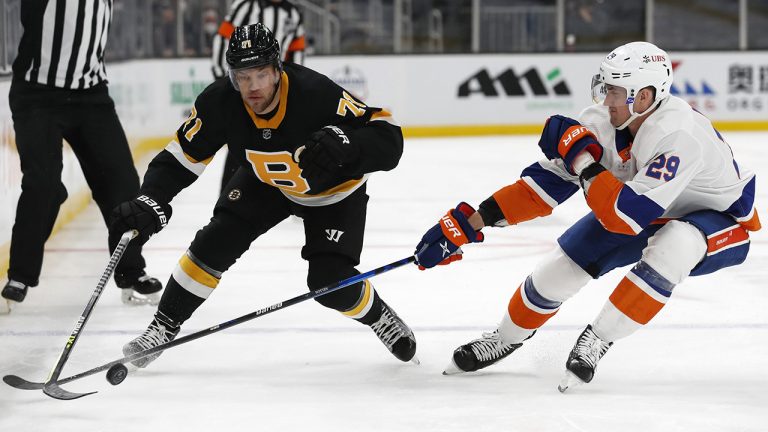 Boston Bruins' Taylor Hall vies for the puck against New York Islanders' Brock Nelson (29) during the first period of an NHL hockey game Friday, April 16, 2021, in Boston. (Winslow Townson/AP)