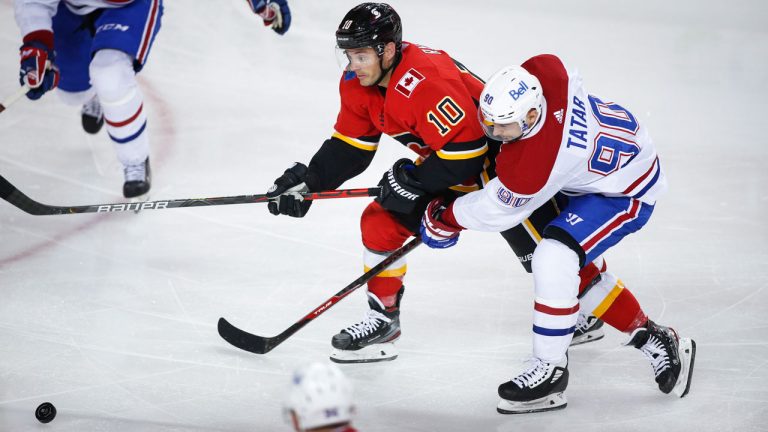 Montreal Canadiens winger Tomas Tatar, right, and Calgary Flames centre Derek Ryan chase the puck. (Jeff McIntosh/CP)