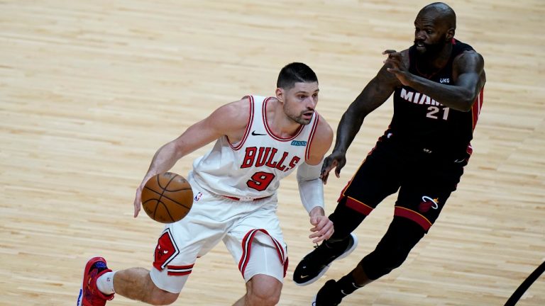 Chicago Bulls center Nikola Vucevic (9) drives to the basket as Miami Heat center Dewayne Dedmon (21) defends during the second half of an NBA basketball game, Monday, April 26, 2021, in Miami. (Lynne Sladky / AP)