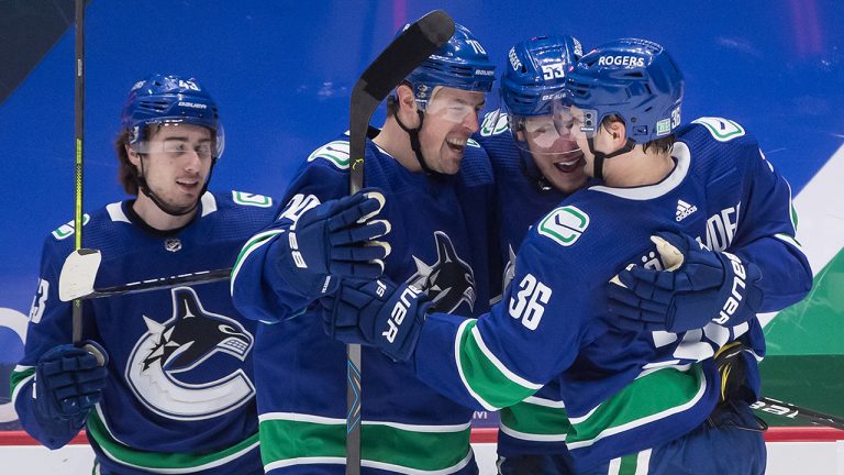 Quinn Hughes, Tanner Pearson, Bo Horvat and Nils Hoglander celebrate Horvat's goal during the second period of an NHL hockey game against the Toronto Maple Leafs on Sunday, April 18, 2021. (Darryl Dyck/CP)