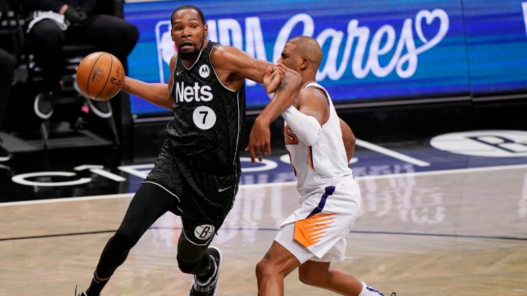 Brooklyn Nets forward Kevin Durant (7) becomes entangled with Phoenix Suns guard Chris Paul during the third quarter of an NBA basketball game, Sunday, April 25, 2021, in New York. (Kathy Willens/AP)
