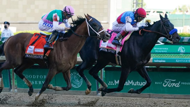 John Valazquez, right, rides Medina Spirit ahead of Florent Geroux aboard Mandaloun to win the 147th running of the Kentucky Derby at Churchill Downs, Saturday, May 1, 2021, in Louisville, Ky. (Darron Cummings/AP)