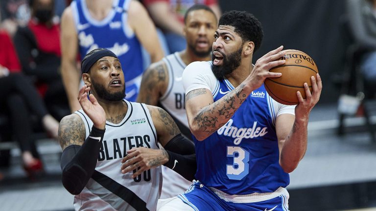 Los Angeles Lakers forward Anthony Davis, right, shoots over Portland Trail Blazers forward Carmelo Anthony during the first half of an NBA basketball game. (Craig Mitchelldyer/AP)