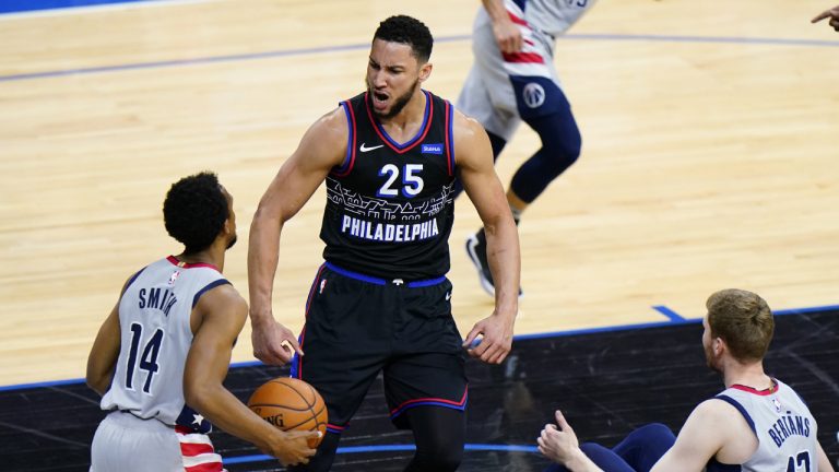 Philadelphia 76ers' Ben Simmons (25) reacts after a dunk as Washington Wizards' Ish Smith (14) and Davis Bertans (42) look on during the first half of Game 2 in a first-round NBA basketball playoff series, Wednesday, May 26, 2021, in Philadelphia. (Matt Slocum/AP)