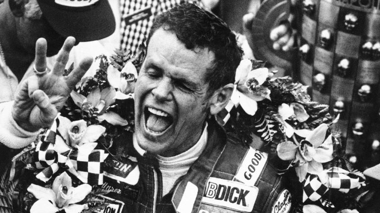 In this May 24, 1981 photo, Bobby Unser holds three fingers aloft after winning his third Indianapolis 500 race. (AP Photo)