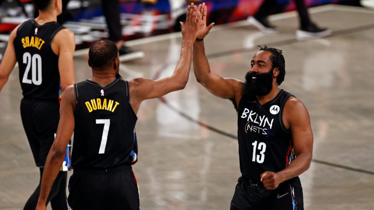 Brooklyn Nets guard James Harden (13) high-fives forward Kevin Durant during the second half of an NBA basketball game against the Chicago Bulls on Saturday, May 15, 2021, in New York. The Nets won 105-91. (AP Photo/Adam Hunger)