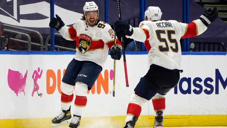 Florida Panthers left wing Ryan Lomberg (94) celebrates after scoring against the Tampa Bay Lightning with center Noel Acciari (55) during overtime in Game 3 of an NHL hockey Stanley Cup first-round playoff series Thursday, May 20, 2021, in Tampa, Fla. (AP Photo/Chris O'Meara)