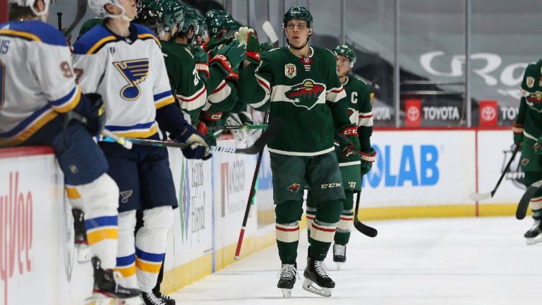 Minnesota Wild's Joel Eriksson Ek (14) high-fives teammates on the bench after scoring a goal against the St. Louis Blues during the second period of an NHL hockey game Thursday, April 29, 2021, in St. Paul, Minn. (Stacy Bengs/AP)