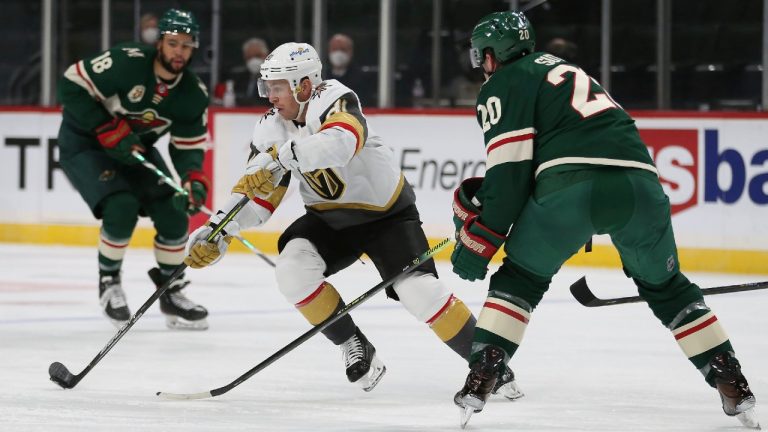 Vegas Golden Knights' Jonathan Marchessault (81) controls the puck against Minnesota Wild's Ryan Suter (20) during the second period of an NHL hockey game Wednesday, March 10, 2021, in St. Paul, Minn. (Stacy Bengs/AP)