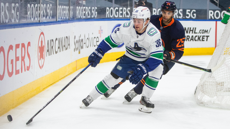 Edmonton Oilers' Darnell Nurse (25) chases Vancouver Canucks' Nils Hoglander (36) during first period NHL action in Edmonton on Thursday, May 6, 2021. (Jason Franson / CP)