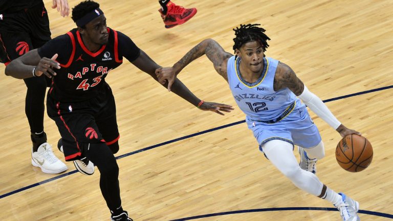 Memphis Grizzlies guard Ja Morant (12) drives ahead of Toronto Raptors forward Pascal Siakam (43) in the first half of an NBA basketball game Monday, Feb. 8, 2021, in Memphis, Tenn. (AP Photo/Brandon Dill)