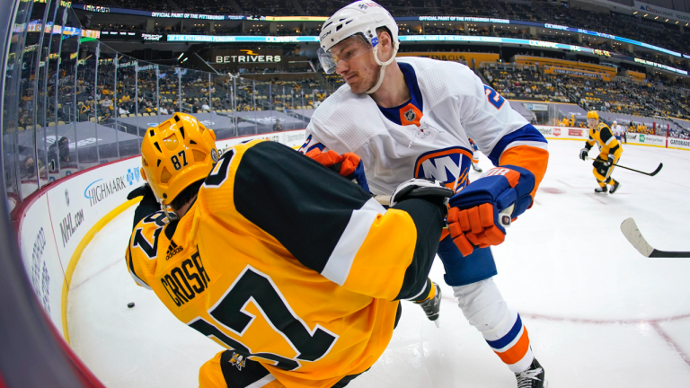 New York Islanders' Scott Mayfield, right, checks Pittsburgh Penguins' Sidney Crosby (87) off his skates during the second period in Game 1 of an NHL hockey Stanley Cup first-round playoff series in Pittsburgh, Sunday, May 16, 2021. (Gene J. Puskar / AP)