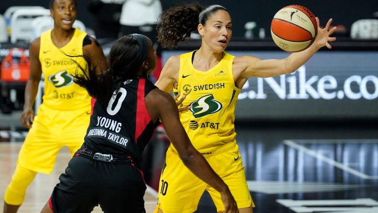 Seattle Storm guard Sue Bird grabs the ball away from Las Vegas Aces guard Jackie Young. (Chris O'Meara/AP)