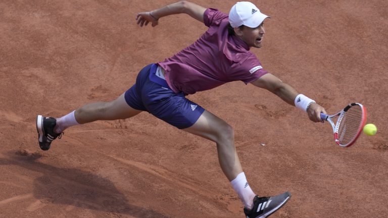 Austria's Dominic Thiem returns the ball to Spain's Pablo Andujar during their first round match of the French Open tennis tournament at the Roland Garros stadium Sunday, May 30, 2021 in Paris. (Christophe Ena/AP)