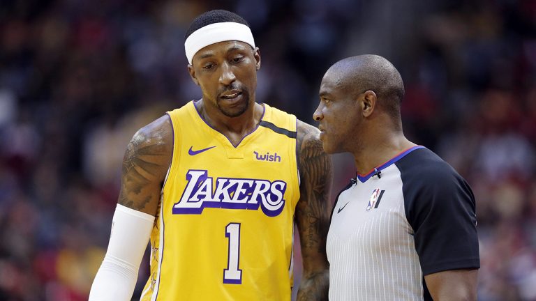 Los Angeles Lakers guard Kentavious Caldwell-Pope talks with referee Tony Brown about a call during the first half of the team's NBA basketball game against the Houston Rockets. (Michael Wyke/AP)