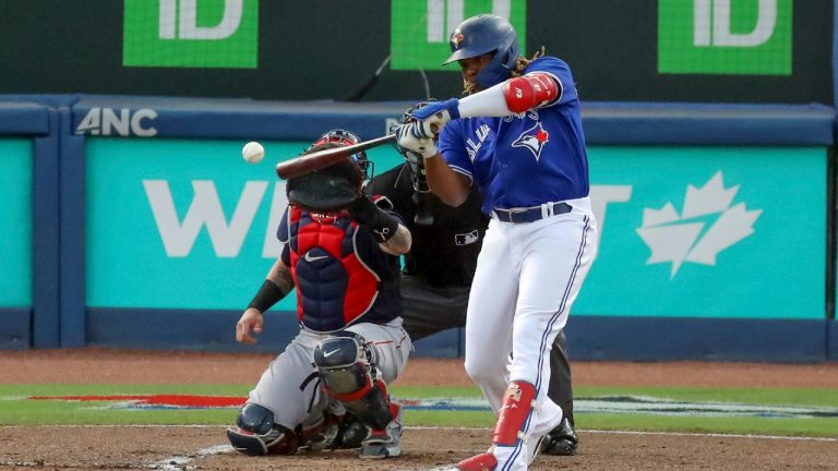 Toronto Blue Jays' Vladimir Guerrero Jr. hits an RBI double in front of Boston Red Sox catcher Christian Vazquez during the first inning of a baseball game Wednesday, May 19, 2021, in Dunedin, Fla. (Mike Carlson/AP)