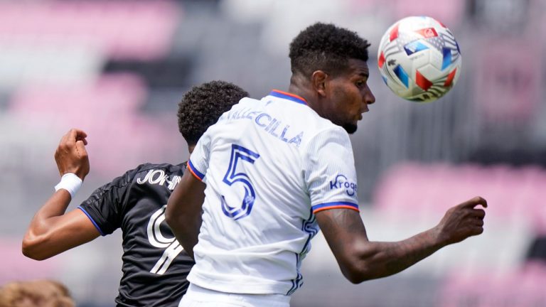 FC Cincinnati defender Gustavo Vallecilla (5) heads the ball against CF Montreal forward Bjorn Johnsen (9) during the second half of an MLS soccer match. (Wilfredo Lee/AP)