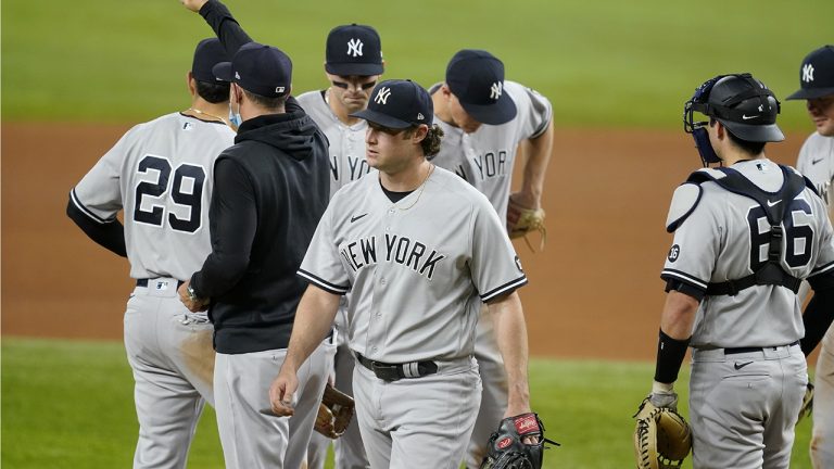 New York Yankees manager Aaron Boone gestures to the bullpen after taking the ball from starting pitcher Gerrit Cole, center, in the sixth inning of a baseball game against the Texas Rangers in Arlington, Texas, Monday, May 17, 2021. (Tony Gutierrez/AP)