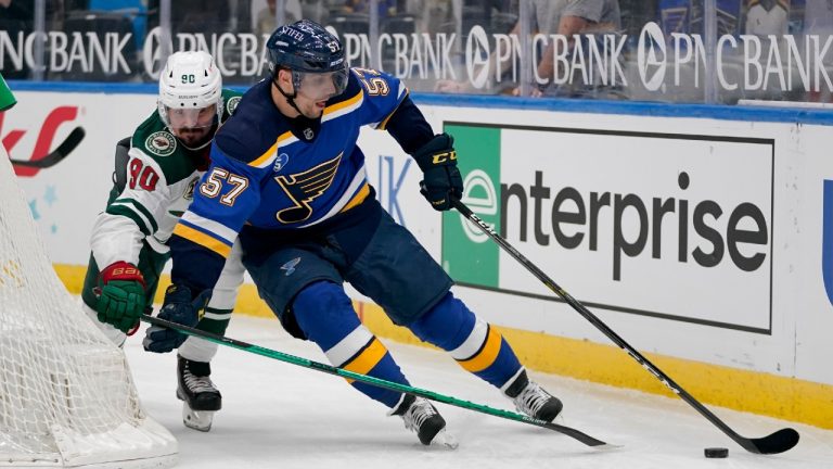 St. Louis Blues' David Perron (57) controls the puck as Minnesota Wild's Marcus Johansson (90) defends during the first period of an NHL hockey game Friday, April 9, 2021, in St. Louis. (Jeff Roberson/AP)