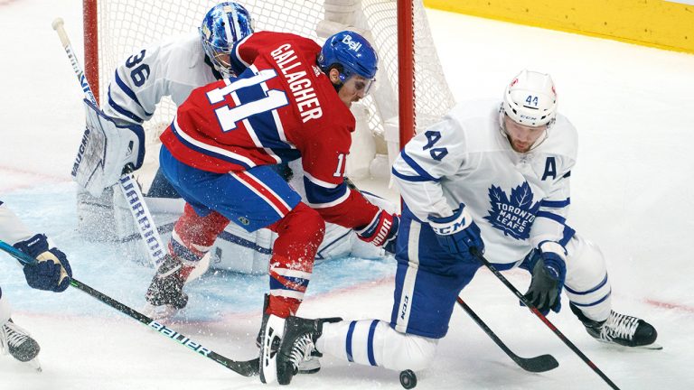 Montreal Canadiens' Brendan Gallagher and Toronto Maple Leafs' Morgan Rielly try to gain control of the puck in front of Leafs goaltender Jack Campbell during first period NHL Stanley Cup playoff hockey action in Montreal, Tuesday, May 25, 2021. (Paul Chiasson/CP) 