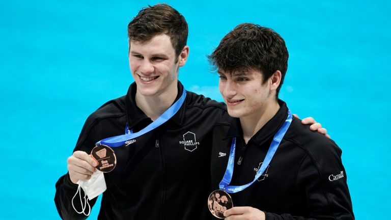 Canada's Vincent Riendeau and Nathan Zsombor-Murray pose for a photo with their bronze medals after the award ceremony of the men's synchronized 10-meter platform competition at the FINA Diving World Cup Saturday, May 1, 2021, at the Tokyo Aquatics Centre in Tokyo. (AP Photo/Eugene Hoshiko)