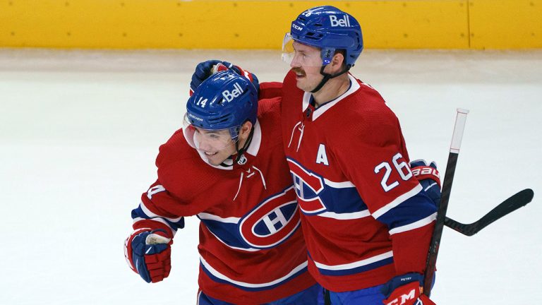 Montreal Canadiens' Nick Suzuki, left, celebrates his goal with teammate Jeff Petry. (Paul Chiasson/CP)