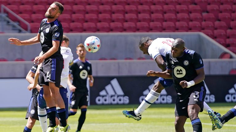 Vancouver Whitecaps forward Cristian Dajome (11) scores on a header as CF Montréal's Kamal Miller (3) and Rudy Camacho (4) defend in the second half during an MLS soccer game Saturday, May 8, 2021, in Sandy, Utah. (Rick Bowmer/AP)