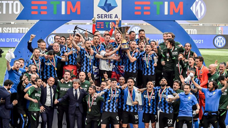 Inter Milan players celebrate with the trophy clinching the Serie A title, after the Serie A soccer match between Inter Milan and Udinese, at the San Siro stadium. (Nicola Marfisi/AP)